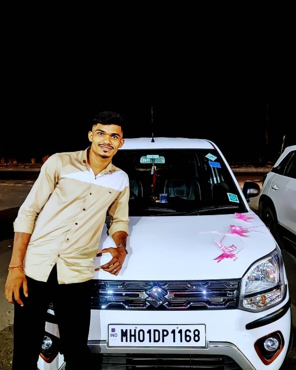 Pankaj Mohite posing with his car