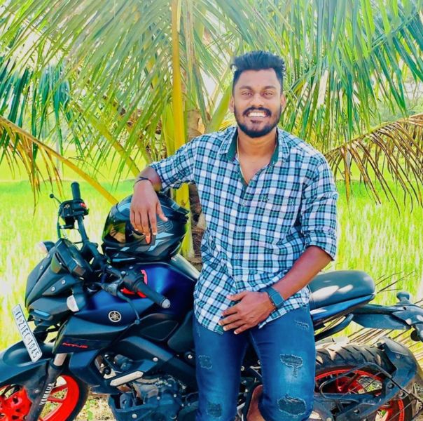 Sachin Prathap posing with his Yamaha MT-15 bike