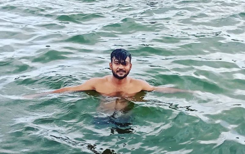 Sagar Sharma swimming in a river