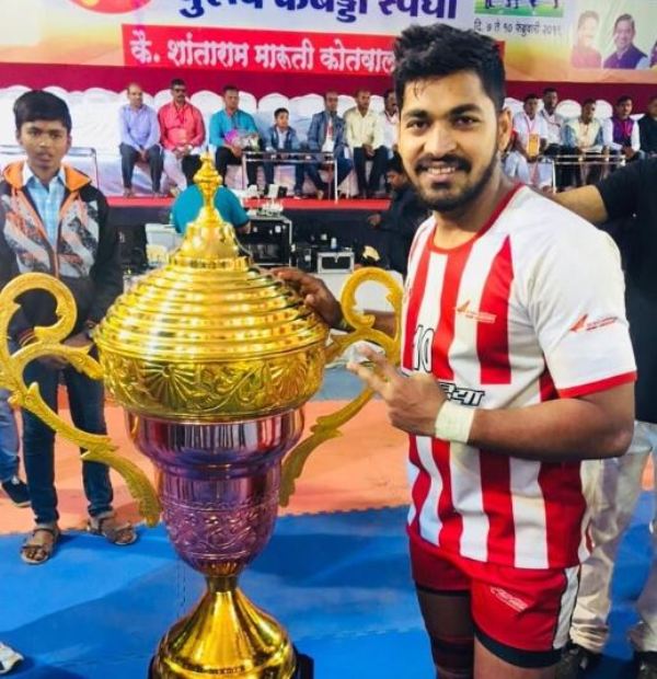 Sanket Sawant posing with the trophy at a Kabaddi tournament in Mumbai