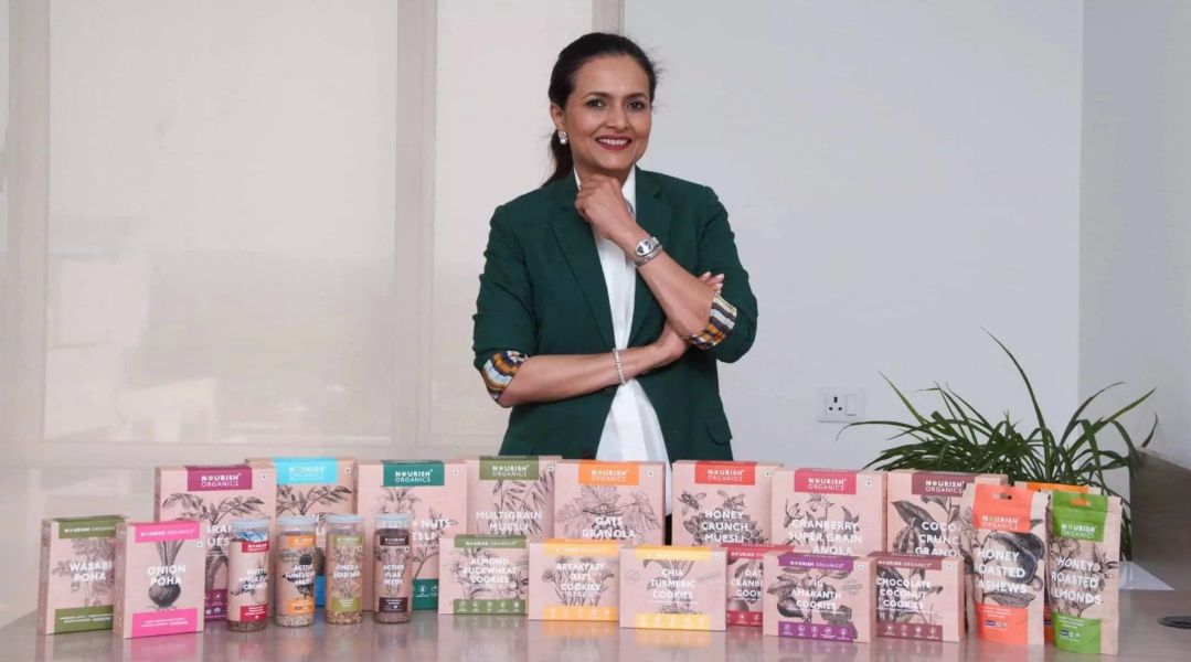 Seema Jajodia posing with her Nourish Organic products
