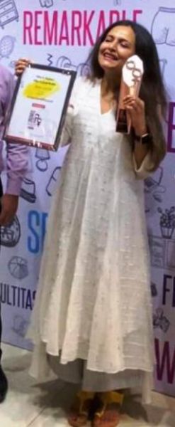 Seema Jajodia posing with her Times She UnLTD Entrepreneur Award