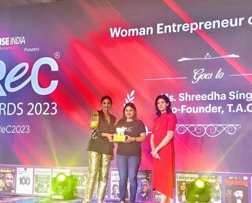 Shreedha Singh receiving Woman Entrepreneur of the Year award in 2023
