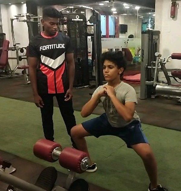 Videsh Anand (right) while working out in a gym