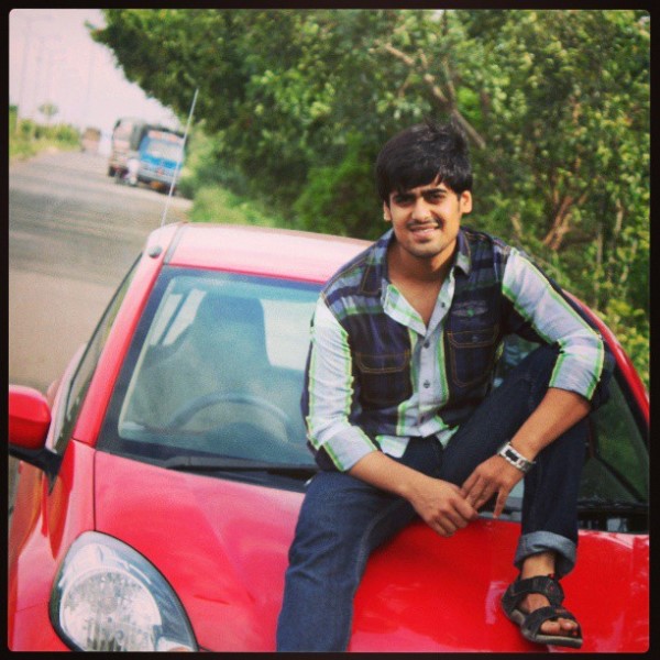 Akash Dodeja posing with his Honda Brio