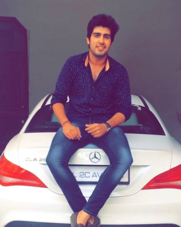 Akash Sansanwal posing with his car