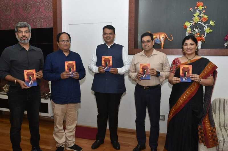 Anurag Pathak (second from left) presenting his book 12th fail to Manoj Sharma (second from right) and his wife (extreme right)