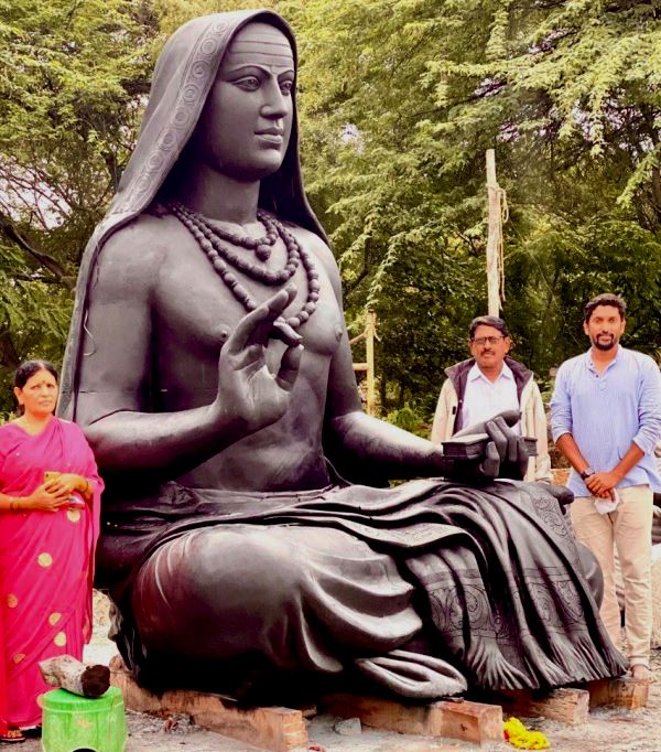 Arun Yogiraj with his parents in front of the statue of Adi Shankaracharya