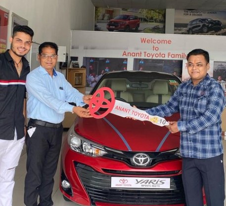 Ashutosh Sharma posing with his Toyota Yaris