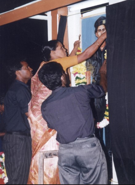 Captain Miller's mother while unveiling his picture at a ceremony