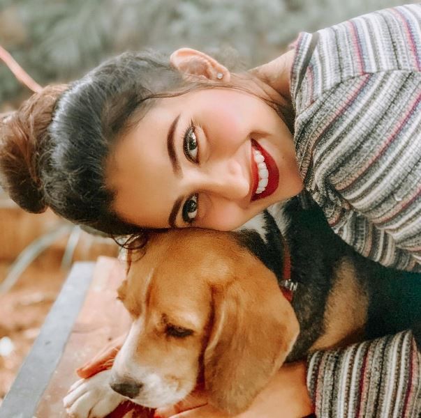 Deepika Pilli while playing with a dog