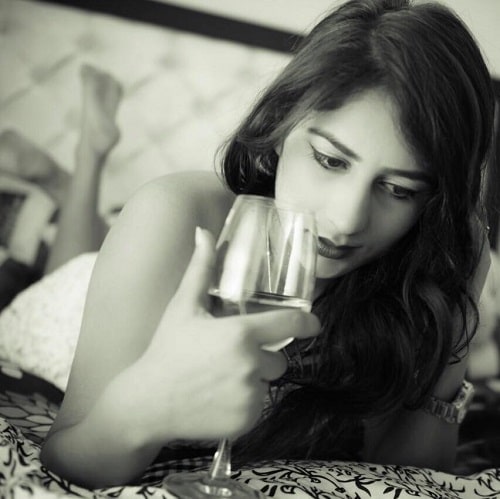 Divya Pahuja holding a glass of wine