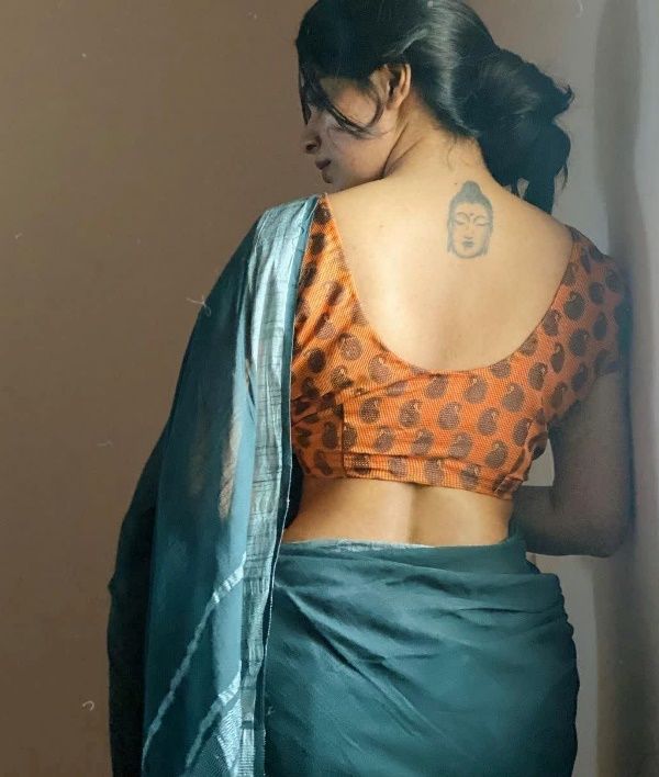 Divyabharathi's tattoo on her back below her neck
