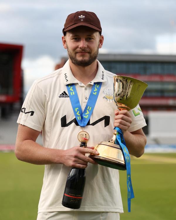 Gus Atkinson with the 2022 County Championship Trophy