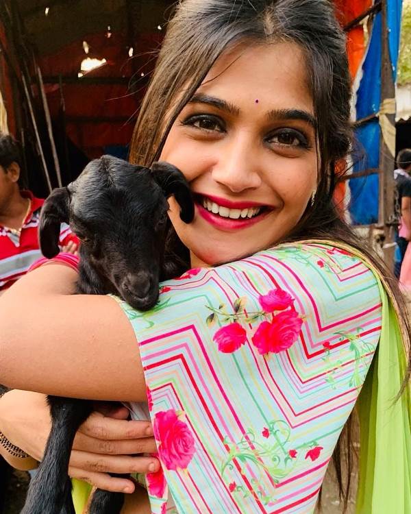 Isha Keskar holding a baby goat