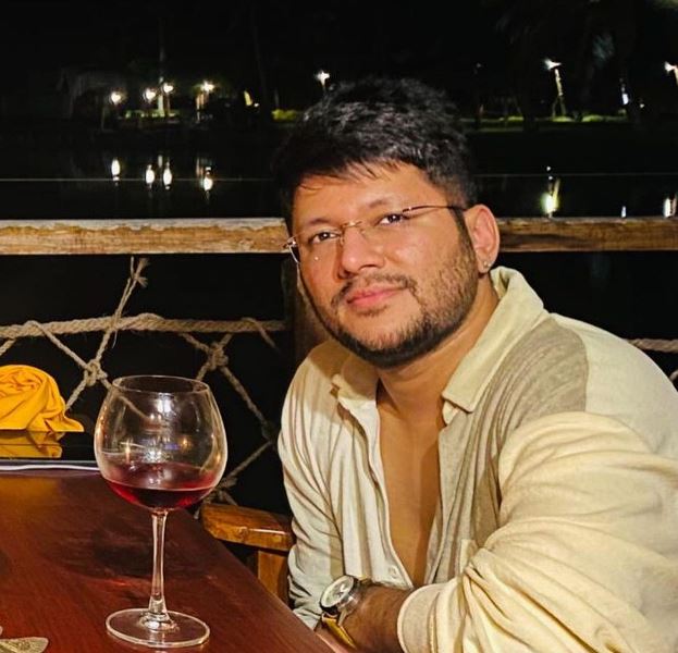 Karan Sharma with a glass of wine