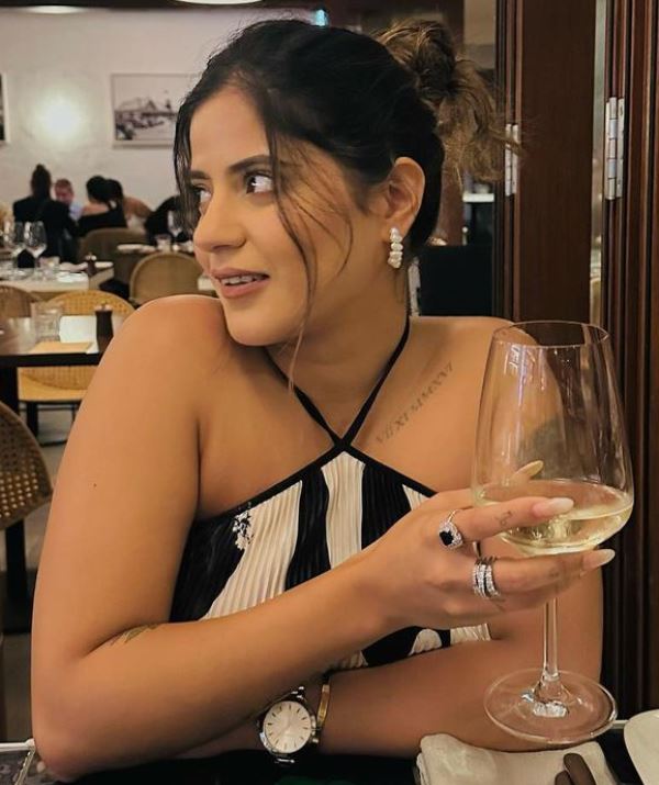 Karnika Budhiraja holding a glass of alcohol