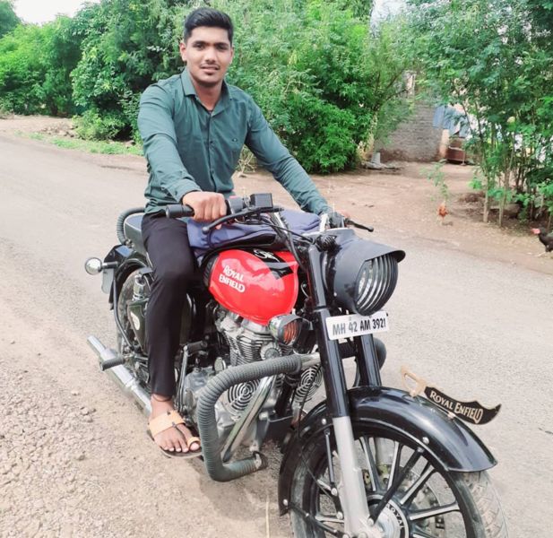 Kiran Magar posing with his bike