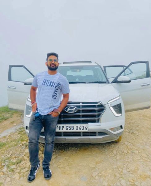 Mahender Singh posing with his car