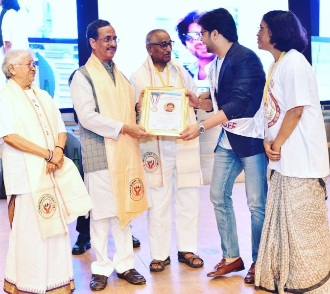Manish Tripathi receiving the Fellow at City Montessori School award