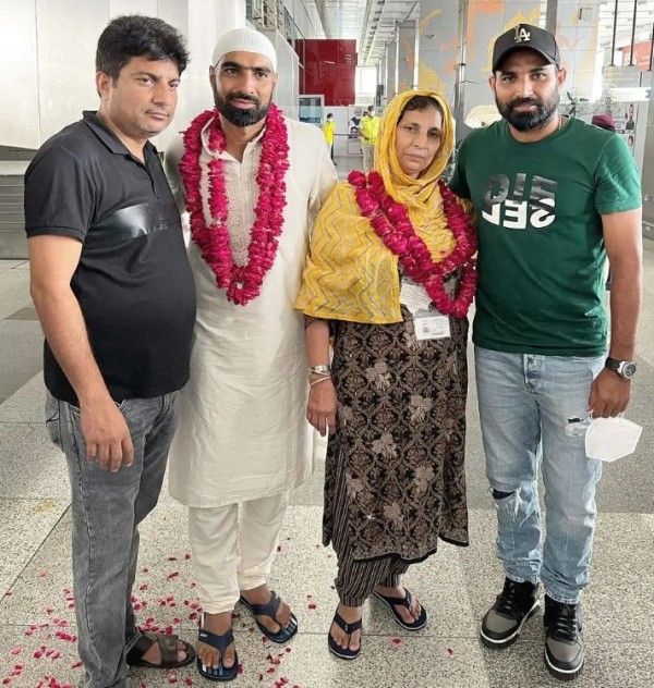 Mohammed Kaif (in white) with his mother, Anjum Ara, and brothers, Haseeb Ahmed (extreme left) and Mohammed Shami
