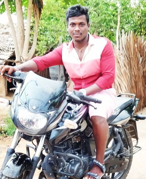 Mukilan Shanmugam posing on his bike