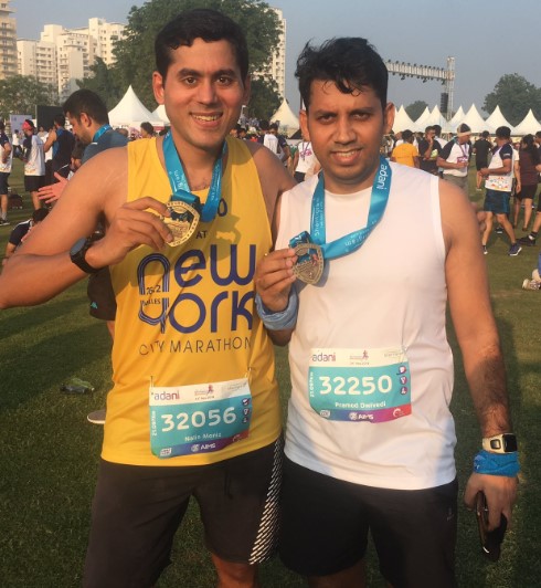 Nalin Moniz (left) after winning a medal in a marathon
