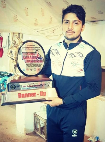 Nitesh Kumar posing with the runners-up trophy of the 66th Senior National Kabaddi Men's Championship in 2019