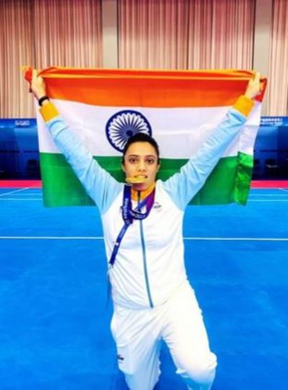Ritu Negi posing with her medal and the Indian flag at the 2022 Asian Games in Hangzhou, China