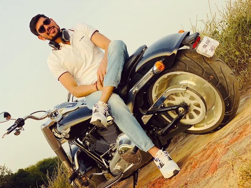 Rohit Kumar posing with his Harley Davidson