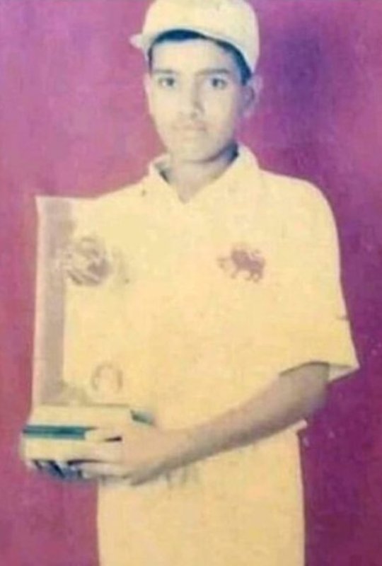 Rohit Sharma with a school cricket trophy