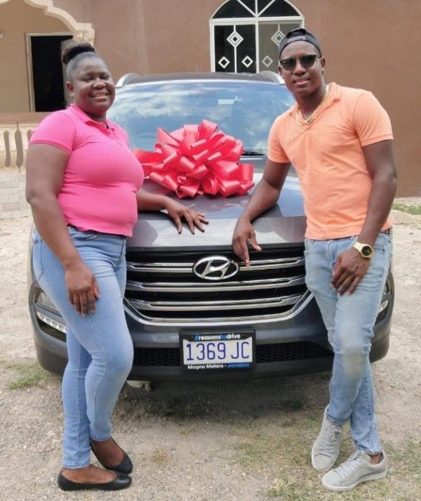 Rovman Powell with his mother after buying her a new car