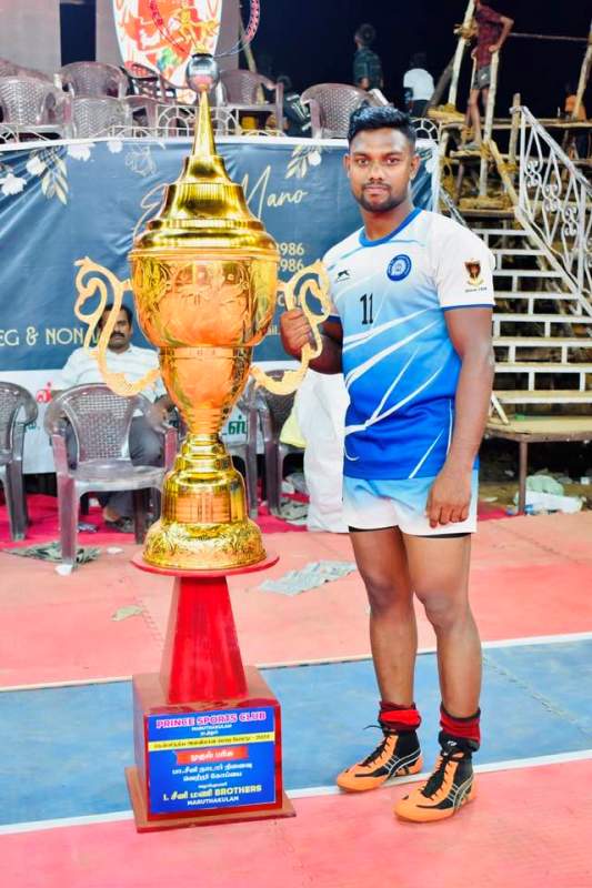 Sajin Chandrasekar posing with the trophy at the South India Kabaddi Match in Tirunelveli