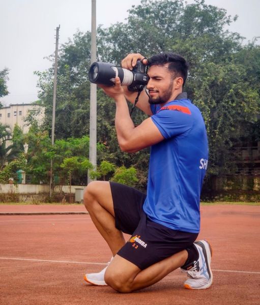 Shivansh Thakur clicking pictures on field