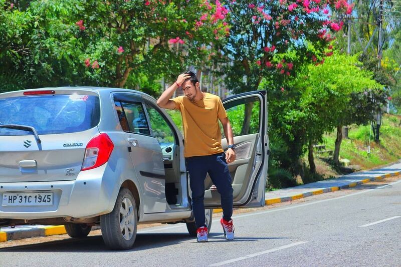 Shivansh Thakur posing with his car