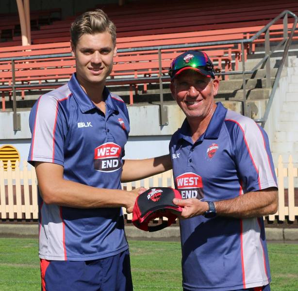 Spencer Johnson receiving his cap from Tim Nielsen (right) on List A debut