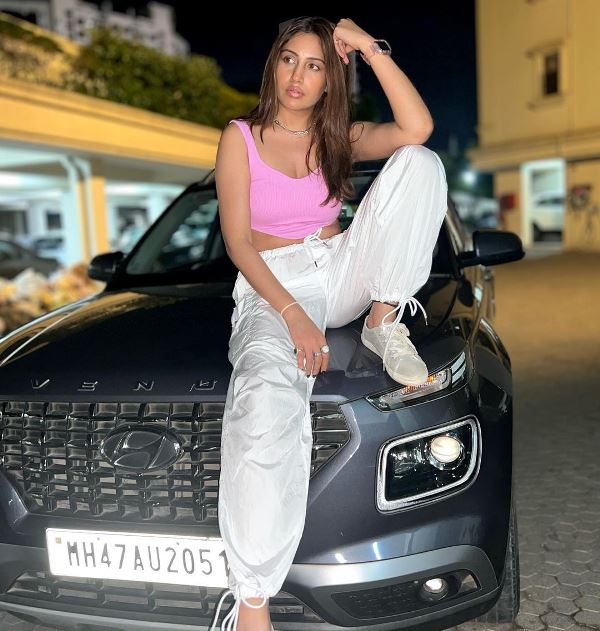 Surbhi Chandna sitting on her car