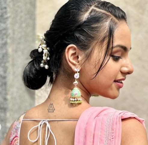 Vaidehi Nair showing a tattoo on her back