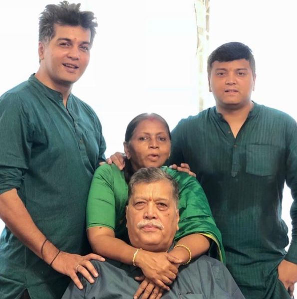 Vinay Rai (left) with his parents and brother (right)