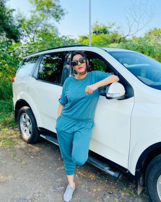 Yamini standing with her car