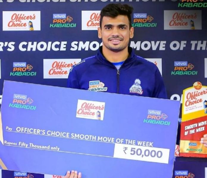 Ashish posing with the cash prize during season 9 of the Pro Kabaddi League