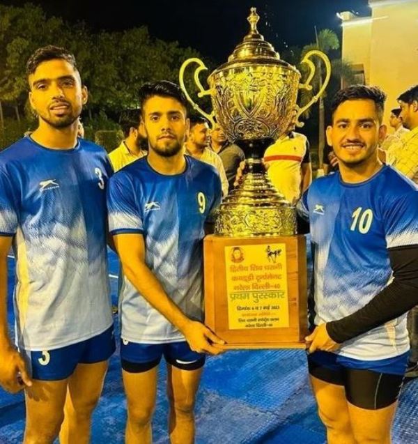 Manish Dhull (extreme right) posing with trophy at a Kabaddi tournament in Narela, Delhi