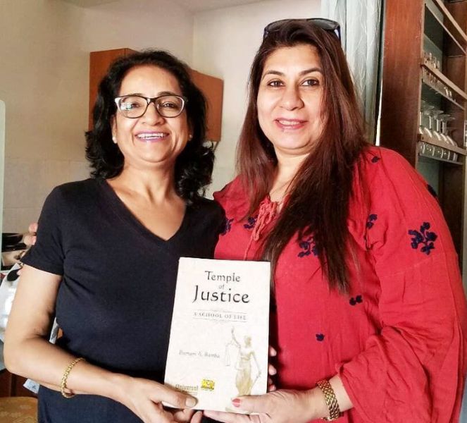 Poonam A. Bamba (left) with her book Temple Of Justice - A School Of Life