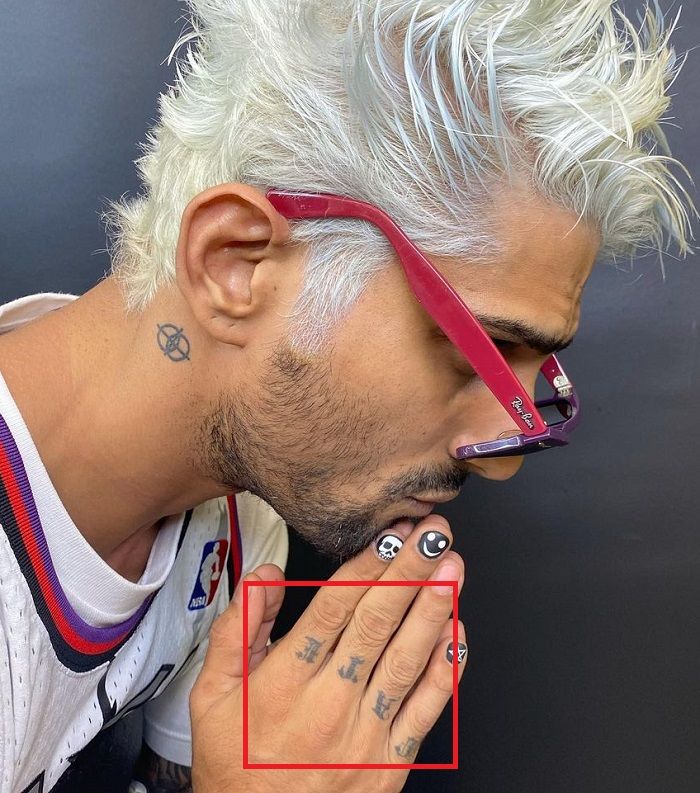 Prateik Babbar's tattoo on his knuckles and a tattoo on the back side of his right ear