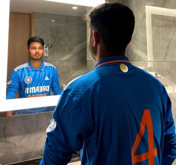 Saumy Pandey while showing his jersey number