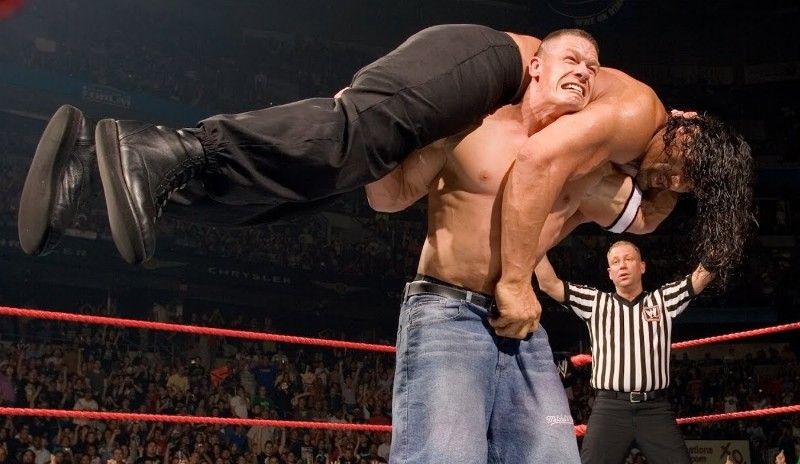 The Great Khali being picked up by John Cena during their match